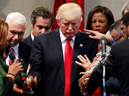 Members of the clergy lay hands and pray over Republican presidential nominee Donald Trump at the New Spirit Revival Center in Cleveland Heights